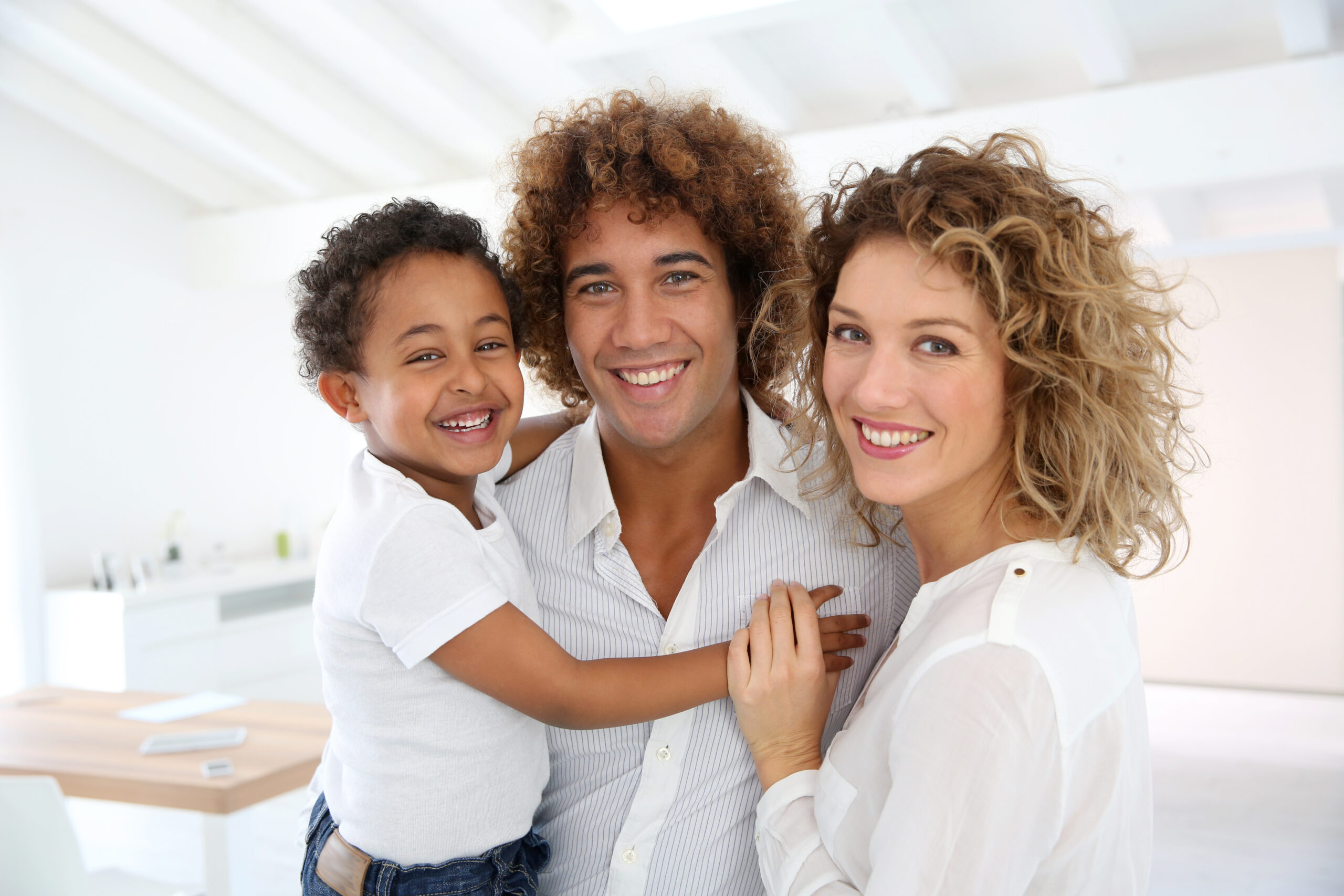 Happy family standing in brand new home